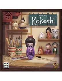 pudełko gry planszowej Kokeshi z japońskimi lalkami i ilustracją kreatywnego biurka