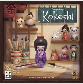 pudełko gry planszowej Kokeshi z japońskimi lalkami i ilustracją kreatywnego biurka